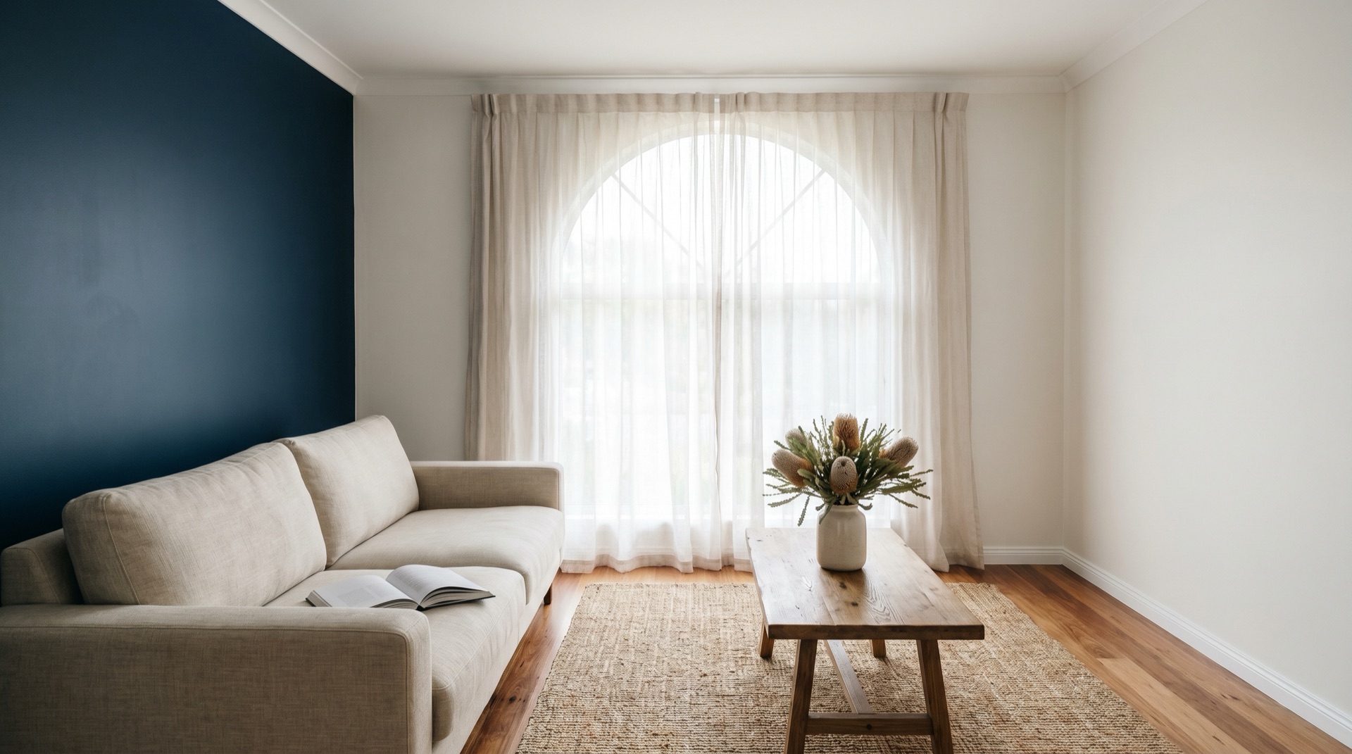 Interior repaint of a coastal living room in Bega with navy feature wall